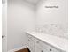 Laundry room with white cabinets and quartz countertops at 9130 Dulwich Dr # Ken0079, Charlotte, NC 28215