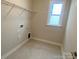 Empty laundry room with wire shelving, ready for personalization and appliances at 9130 Dulwich Dr # Ken0079, Charlotte, NC 28215