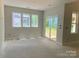 Bright living room featuring large windows and sliding glass door for natural light at 9130 Dulwich Dr # Ken0079, Charlotte, NC 28215