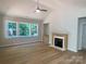 Cozy living room featuring a fireplace, large windows, and ample natural light at 9130 Dulwich Dr # Ken0079, Charlotte, NC 28215