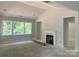 Unfinished living room with multiple windows and a cozy fireplace setup at 9130 Dulwich Dr # Ken0079, Charlotte, NC 28215