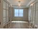Home office with natural light, hardwood floors, and a modern light fixture at 9130 Dulwich Dr # Ken0079, Charlotte, NC 28215