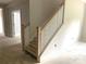Staircase with white railings and natural wood accents, connecting the home's levels at 9130 Dulwich Dr # Ken0079, Charlotte, NC 28215