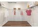 A large walk-in closet features ample shelving and hanging space at 9130 Dulwich Dr # Ken0079, Charlotte, NC 28215