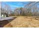 Large backyard with concrete patio and mature trees at 1097 Georgetown Rd, Lincolnton, NC 28092