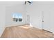 Bedroom with light wood floors, vaulted ceilings, and a view of the front yard at 1097 Georgetown Rd, Lincolnton, NC 28092