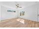 Bright bedroom with a modern ceiling fan, light wood floors, and white walls at 1097 Georgetown Rd, Lincolnton, NC 28092