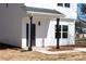 Charming white two-story home featuring a welcoming porch, black door, and modern design at 1097 Georgetown Rd, Lincolnton, NC 28092