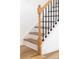 Elegant staircase features light wood treads, white risers and walls, plus black iron balusters at 1097 Georgetown Rd, Lincolnton, NC 28092