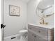 Updated bathroom with gray vanity and gold fixtures at 201 Seneca Pl, Charlotte, NC 28210