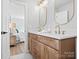 Modern bathroom with double vanity, quartz countertops, and gold fixtures at 201 Seneca Pl, Charlotte, NC 28210