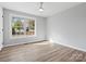 Simple bedroom with wood floors and large window at 201 Seneca Pl, Charlotte, NC 28210