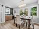 Bright dining area with wood table and chairs, near kitchen and windows at 201 Seneca Pl, Charlotte, NC 28210