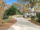 Long driveway to a renovated white brick home at 201 Seneca Pl, Charlotte, NC 28210