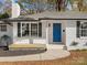 White brick ranch with blue door and landscaping at 201 Seneca Pl, Charlotte, NC 28210