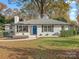 Front view of renovated white brick ranch at 201 Seneca Pl, Charlotte, NC 28210