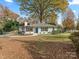 White brick ranch house with landscaped yard at 201 Seneca Pl, Charlotte, NC 28210