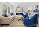 Living room with light beige sofa, blue armchairs, and a modern fireplace at 201 Seneca Pl, Charlotte, NC 28210