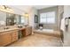 Bathroom with soaking tub, double sinks, and shower at 3014 Highbury Pl, Weddington, NC 28104