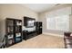 Bonus room with TV, shelving, and comfortable seating at 3014 Highbury Pl, Weddington, NC 28104