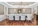 Formal dining room with a large table, chandelier, and hardwood floors at 3014 Highbury Pl, Weddington, NC 28104