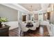 Bright dining room with hardwood floors and a large chandelier at 3014 Highbury Pl, Weddington, NC 28104