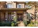 Inviting front porch with rocking chairs and a decorative wreath at 3014 Highbury Pl, Weddington, NC 28104