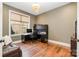 Bright home office features built-in shelving and hardwood floors at 3014 Highbury Pl, Weddington, NC 28104