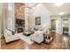 Open living room showcasing a stone fireplace and hardwood floors at 3014 Highbury Pl, Weddington, NC 28104