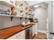 Well-organized pantry with ample shelving and wood countertop at 3014 Highbury Pl, Weddington, NC 28104