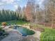 Freeform pool with stone patio and lounge chairs at 3014 Highbury Pl, Weddington, NC 28104