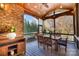 Screened porch with brick wall and dining furniture at 3014 Highbury Pl, Weddington, NC 28104