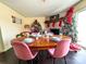 Festive dining room with a Christmas tree, a decorative fireplace and stylish, pink chairs surrounding the dining table at 507 Texas Trl, Dallas, NC 28034