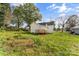 View of home's exterior, featuring a backyard, wooden deck, and well-maintained lawn at 612 E E St, Newton, NC 28658