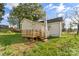 Home's exterior showing backyard, wooden deck, and well-maintained lawn and gardens at 612 E E St, Newton, NC 28658