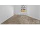 A minimalist bedroom features carpeted floors and a window allowing natural light at 612 E E St, Newton, NC 28658