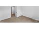 This is a simple, carpeted bedroom with fresh, white paint and a closet at 612 E E St, Newton, NC 28658