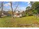 Single-Gathering home featuring a red front door, covered front porch, and large grassy yard at 612 E E St, Newton, NC 28658