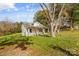 Charming single-Gathering home features a red front door, green lawn, and mature shade trees at 612 E E St, Newton, NC 28658