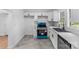 Open kitchen showcasing updated appliances, white cabinets, and generous counter space at 612 E E St, Newton, NC 28658