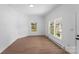 This is a living room with vinyl floors, large windows, and fresh white paint at 612 E E St, Newton, NC 28658