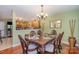 Dining room with hardwood floors, chandelier, and views of kitchen at 7546 Lady Liberty Ln, Charlotte, NC 28217