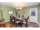 Formal dining room with hardwood floors and a wood table at 7546 Lady Liberty Ln, Charlotte, NC 28217