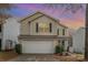 Two-story house with beige siding, a white garage door, and landscaping at 7546 Lady Liberty Ln, Charlotte, NC 28217