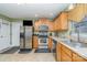 Eat-in kitchen with stainless steel appliances and wood cabinets at 7546 Lady Liberty Ln, Charlotte, NC 28217