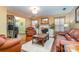 Spacious living room featuring hardwood floors, a fireplace, and leather furniture at 7546 Lady Liberty Ln, Charlotte, NC 28217