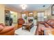 Spacious living room featuring hardwood floors, a fireplace, and leather furniture at 7546 Lady Liberty Ln, Charlotte, NC 28217