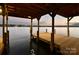 Covered boat dock with serene lake views, perfect for relaxation at 8058 Edgewater Dr, Norwood, NC 28128