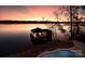 Private boathouse with covered deck and stunning sunset view over lake at 8058 Edgewater Dr, Norwood, NC 28128