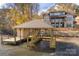 Lakefront boathouse with a covered area and multiple docks at 8058 Edgewater Dr, Norwood, NC 28128